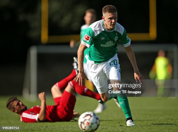 Igro Casanova of Bremerhaven and Aron Johannsson of Werder Bremen battle for the ball during the friendly match between OSC Bremerhaven and Werder...