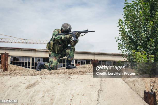 soldier in action - airsoft gun stock pictures, royalty-free photos & images