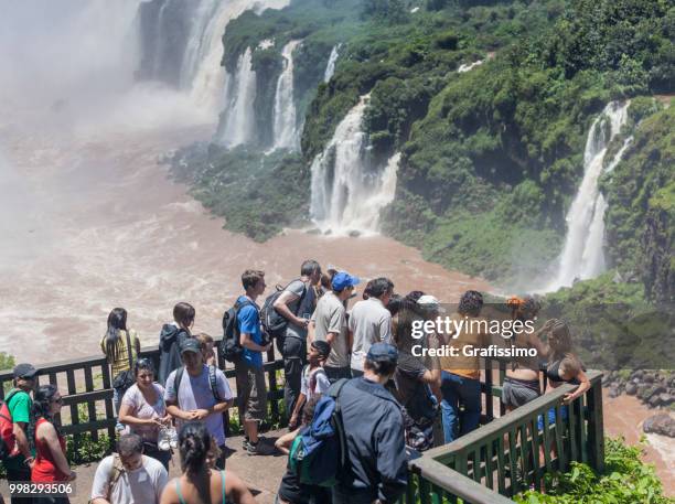 brazil tourists standing in front of waterfalls in iguacu on vacations - grafissimo stock pictures, royalty-free photos & images