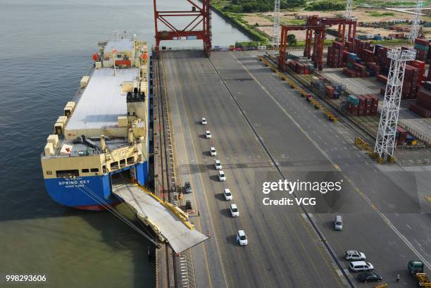 One hundred BYD e6 automobiles are exported from Shenzhen to Thailand by roll-on/roll-off ships at Dachan Bay Terminals on July 12, 2018 in Shenzhen,...