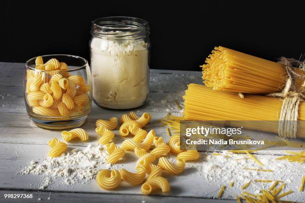 pasta and flour on a wooden background - nadia stock pictures, royalty-free photos & images