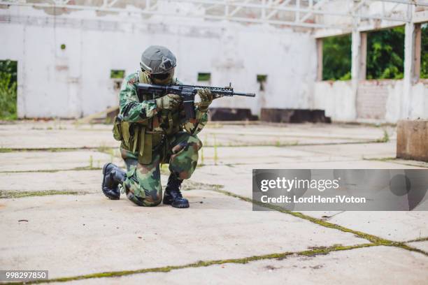 soldier with gun ready to fire. - airsoft gun stock pictures, royalty-free photos & images