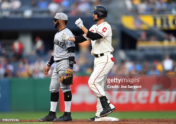 Jordy Mercer of the Pittsburgh Pirates celebrates his RBI double in front of Jonathan Villar of the Milwaukee Brewers during the third inning at PNC...