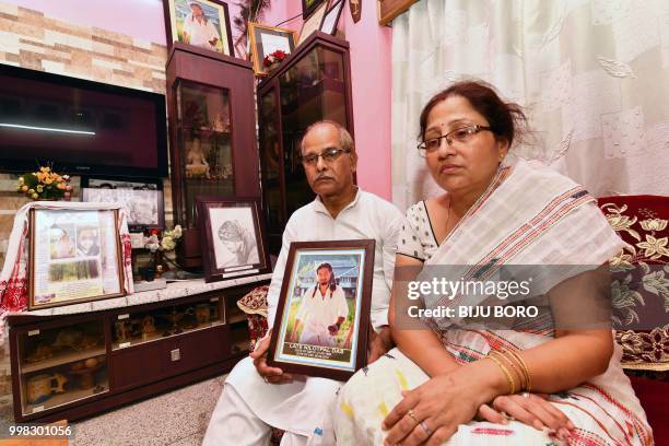 This photo taken on July 9, 2018 shows Gopal Chandra Das and Radhika Das , parents of lynching victim Nilotpal Das, speaking to journalists at their...