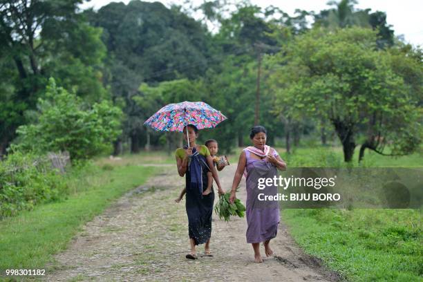 This photo taken on July 10, 2018 shows villagers near the site of the lynching of two men in Panjuri Kachari village, in Karbi Anglong district some...