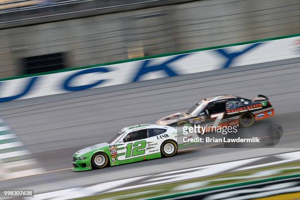 Austin Cindric, driver of the Lasik Vision Institute Ford, leads Justin Allgaier, driver of the Dale Jr's Whisky River Chevrolet, during the NASCAR...