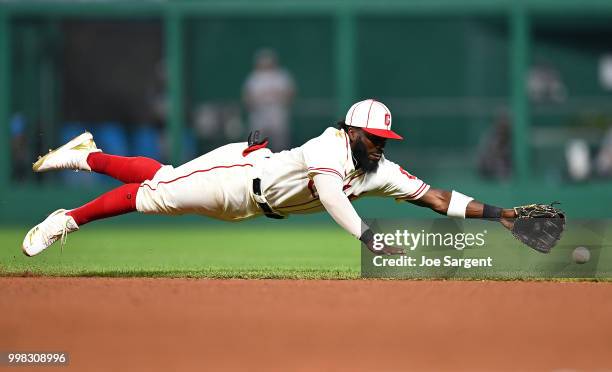 Josh Harrison of the Pittsburgh Pirates can't make a catch on a ball hit by Lorenzo Cain of the Milwaukee Brewers during the eighth inning at PNC...