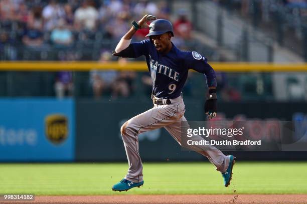 Dee Gordon of the Seattle Mariners advances to third base after the ball got past the first baseman on a pickoff attempt in the first inning of a...