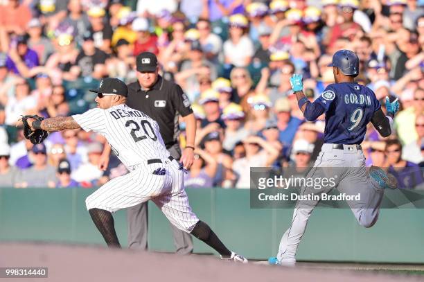 Ian Desmond of the Colorado Rockies forces out Dee Gordon of the Seattle Mariners on a close play at first base in the second inning of a game at...