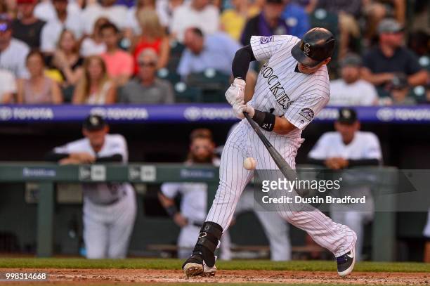 Tony Wolters of the Colorado Rockies hits into a fielders choice for a second inning game-tying RBI against the Seattle Mariners at Coors Field on...
