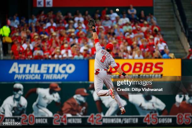 Jose Peraza of the Cincinnati Reds attempts to catch a line drive against the St. Louis Cardinals in the first inning at Busch Stadium on July 13,...