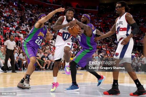 Nate Robinson of Tri-State dribbles the ball between Salim Stoudamire and Reggie Evans of the 3 Headed Monsters during BIG3 - Week Four at Little...