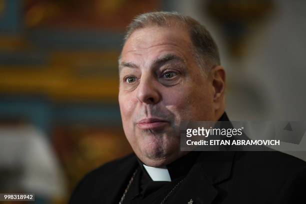 The auxiliary bishop of La Plata -60 km south of Buenos Aires- Alberto Bochatey speaks during an interview with AFP in Buenos Aires on July 5, 2018....