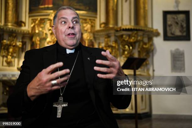 The auxiliary bishop of La Plata -60 km south of Buenos Aires- Alberto Bochatey speaks during an interview with AFP in Buenos Aires on July 5, 2018....