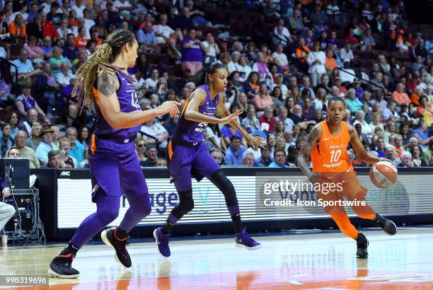 Connecticut Sun guard Courtney Williams drives to the basket against Phoenix Mercury forward DeWanna Bonner and Phoenix Mercury center Brittney...