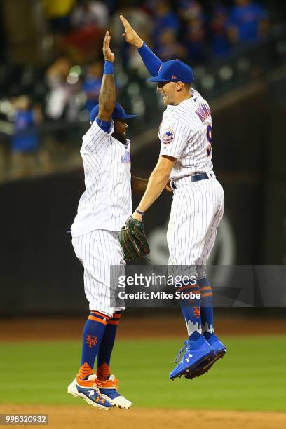 Jose Reyes and Brandon Nimmo of the New York Mets celebrate thier 4-2 victory againt the Washington Nationals at Citi Field on July 13, 2018 in the...