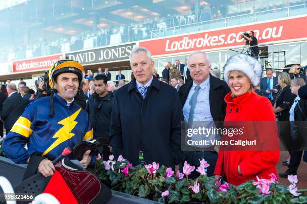 Dwayne Dunn poses with owners after riding Brutal in Race 1 during Melbourne Racing at Caulfield Racecourse on July 14, 2018 in Melbourne, Australia.