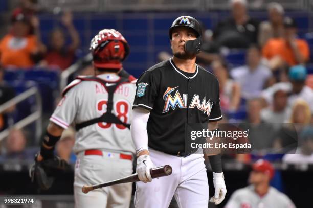 Miguel Rojas of the Miami Marlins walks back to the dugout after striking out in the eighth inning against the Philadelphia Phillies at Marlins Park...