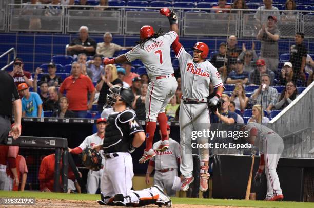Maikel Franco of the Philadelphia Phillies high fives Aaron Altherr after hitting a home run in the ninth inning against the Miami Marlins at Marlins...
