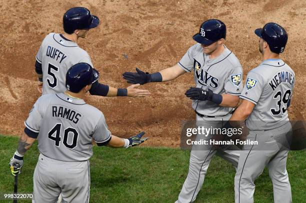 Wilson Ramos, Matt Duffy and Kevin Kiermaier of the Tampa Bay Rays congratulate teammate Jake Bauers on a three-run home run against the Minnesota...