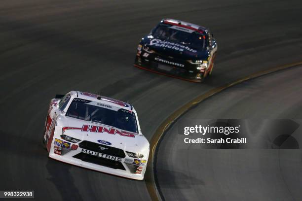 Cole Custer, driver of the Haas Automation Ford, leads Jeremy Clements, driver of the RepairableVehicles.com Chevrolet, during the NASCAR Xfinity...