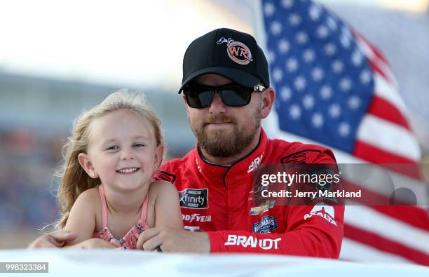 Justin Allgaier, driver of the Dale Jr's Whisky River Chevrolet, rides with his daughter, Harper Grace, during driver introductions prior to the...