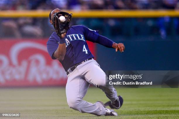 Denard Span of the Seattle Mariners makes a sliding catch of a short fly ball in the fourth inning of a game against the Colorado Rockies at Coors...