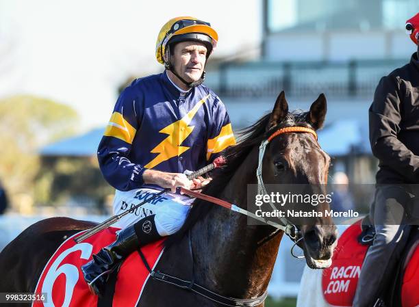 Dwayne Dunn returns to the mounting yard on Brutal after winning the Ladbrokes.com.au Handicap , at Caulfield Racecourse on July 14, 2018 in...