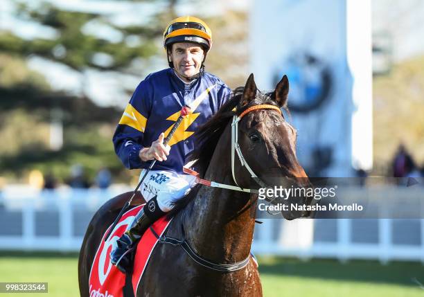 Dwayne Dunn returns to the mounting yard on Brutal after winning the Ladbrokes.com.au Handicap , at Caulfield Racecourse on July 14, 2018 in...