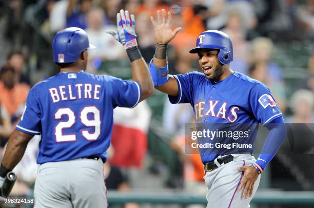 Elvis Andrus of the Texas Rangers celebrates with Adrian Beltre after scoring in the seventh inning against the Baltimore Orioles at Oriole Park at...