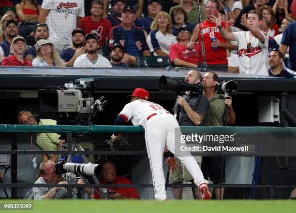 Jose Ramirez of the Cleveland Indians runs into the railing of the third base photo bay chasing a foul ball hit by Brett Gardner the New York Yankees...