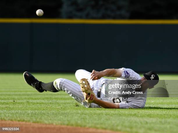 Colorado Rockies second baseman DJ LeMahieu throws to first, but not in time to throw out Seattle Mariners second baseman Dee Gordon in first the...