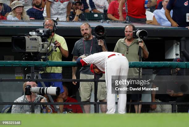 Jose Ramirez of the Cleveland Indians runs into the railing of the third base photo bay chasing a foul ball hit by Brett Gardner the New York Yankees...
