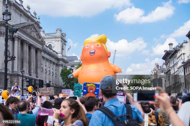 Large Balloon of Donal Trump is paraded down Whitehall during the demonstration. Protest against US President Donald Trumps visit to the UK on the...