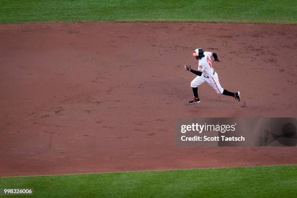 Adam Jones of the Baltimore Orioles advances to third against the Philadelphia Phillies during the second inning at Oriole Park at Camden Yards on...