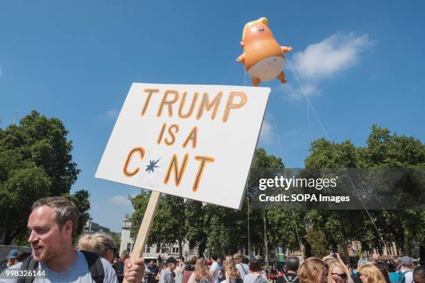 Protester is seen holding a poster during the demonstration against US President Donald Trumps visit to the UK on the second day of the president's...