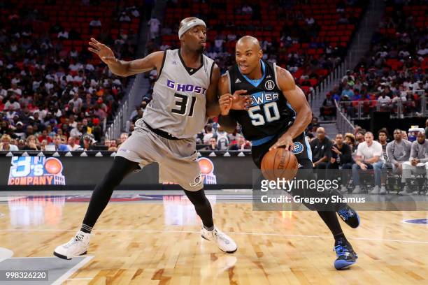 Corey Maggette of Power dribbles the ball while being guarded by Ricky Davis of the Ghost Ballers during BIG3 - Week Four at Little Caesars Arena on...