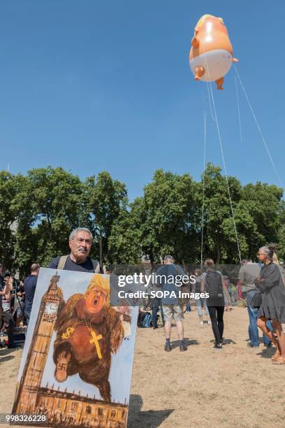 Protester is seen holding a sign against Donald Trump during the demonstration. Protest against US President Donald Trumps visit to the UK on the...