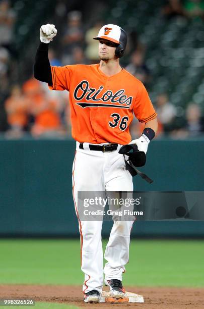 Caleb Joseph of the Baltimore Orioles celebrates after driving in three runs with a double in the seventh inning against the Texas Rangers at Oriole...