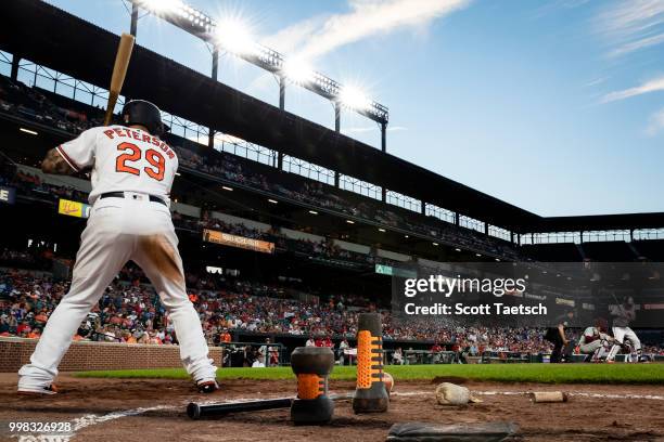 Jace Peterson of the Baltimore Orioles warms up in the batters circle against the Philadelphia Phillies during the seventh inning at Oriole Park at...