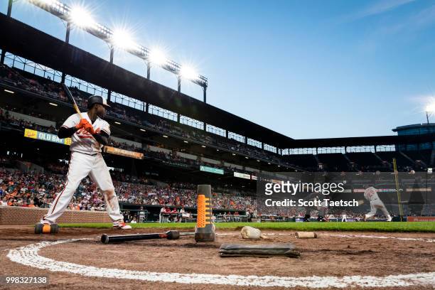 Tim Beckham of the Baltimore Orioles warms up in the batters circle as Jace Peterson hits a solo home run against the Philadelphia Phillies during...