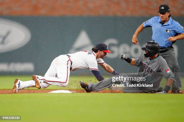 Nick Ahmed of the Arizona Diamondbacks slides into second beating the tag of Dansby Swanson of the Atlanta Braves in the seventh inning of an MLB...