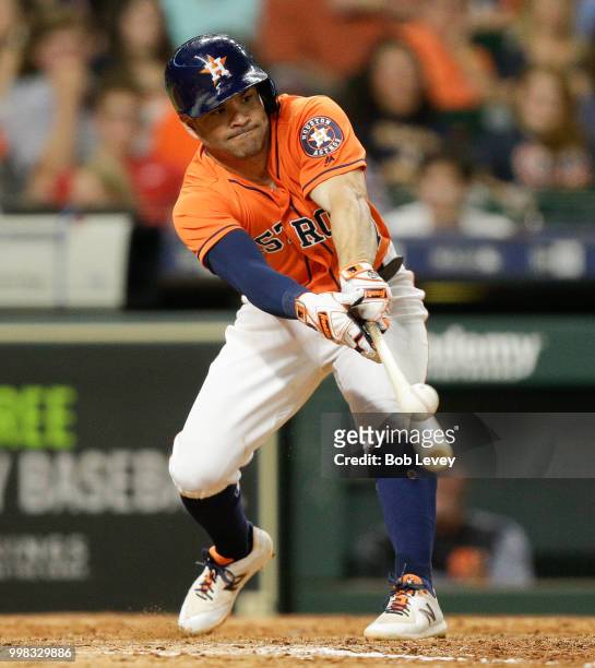 Jose Altuve of the Houston Astros singles in the eighth inning against the Detroit Tigers at Minute Maid Park on July 13, 2018 in Houston, Texas.