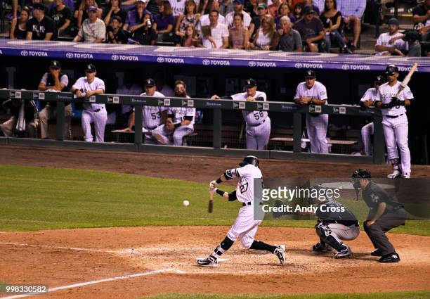 Colorado Rockies shortstop Trevor Story doubles to deep right center scoring teammate Nolan Arenado and Gonzalez in the 6th inning at Coors Field...