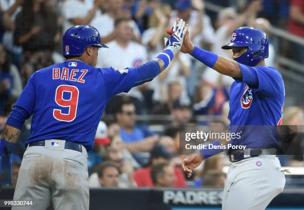 Addison Russell of the Chicago Cubs, right, and Javier Baez celebrated after scoring during the second inning of a baseball game against the San...