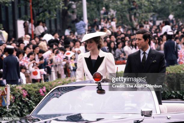 Prince Charles, Prince of Wales and Princess Diana, Princess of Wales wave to well-wishers during the parade on May 11, 1986 in Tokyo, Japan.