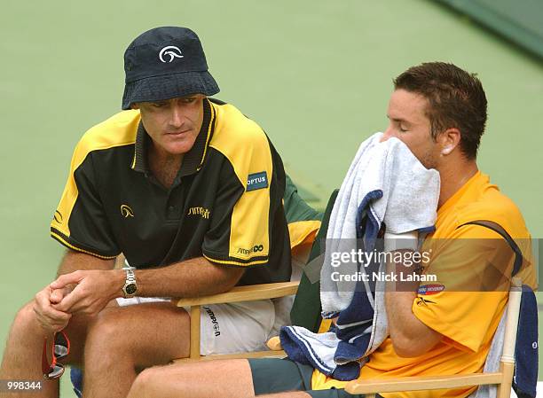 Coach John Fitzgerald talks with Pat Rafter of Australia in the Davis Cup Semi Final match against Thomas Johansson of Sweden held at the Sydney...