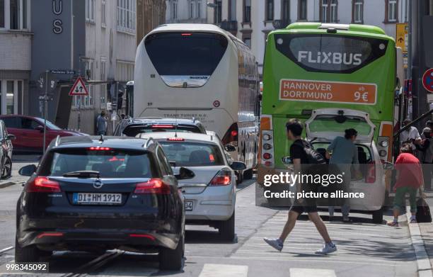 July 2018, Germany, Frankfurt: Buses blocking traffic at the central station. There are constant chaotic transport scences at the bus parking area on...