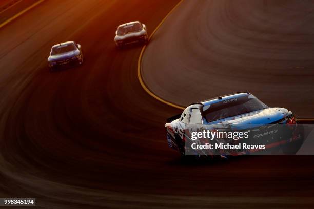 Kyle Busch, driver of the NOS Energy Drink Toyota, leads a pack of cars during the NASCAR Xfinity Series Alsco 300 at Kentucky Speedway on July 13,...