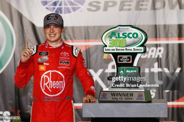 Christopher Bell, driver of the Rheem Toyota, poses in Victory Lane after winning the NASCAR Xfinity Series Alsco 300 at Kentucky Speedway on July...